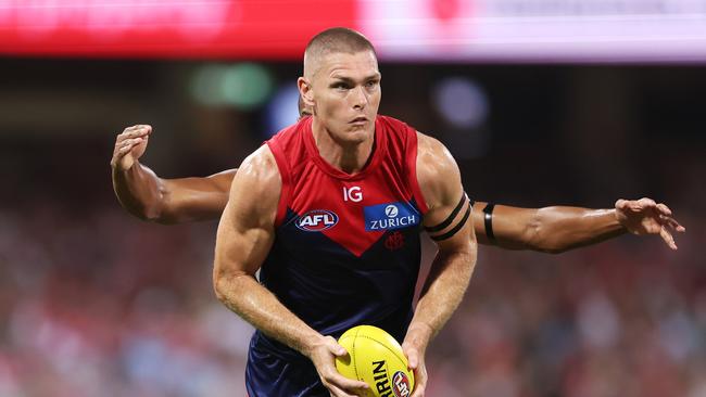 SYDNEY, AUSTRALIA - MARCH 07:  Adam Tomlinson of the Demons handles the ball during the Opening Round AFL match between Sydney Swans and Melbourne Demons at SCG, on March 07, 2024, in Sydney, Australia. (Photo by Matt King/AFL Photos/Getty Images)