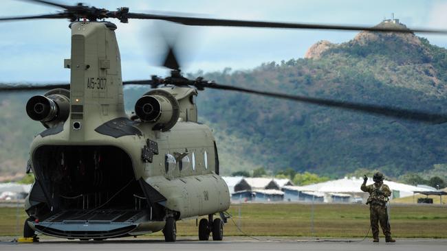 An Army CH-47F Chinook helicopter on the flightline at RAAF Base Townsville in Queensland. The Bushmasters have been treated with a special blast mitigation coating from Gold Coast company Rhino Linings. Photo: Department of Defence