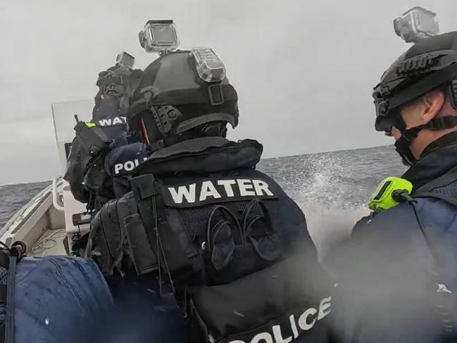 Armed police on their way to raid the boat. Supplied by NSW Police.