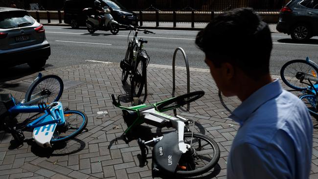 Share e-bikes lay tipped over on the sidewalk at Martin Place, Sydney. A loophole has been exposed, with police not having the power to randomly breath test riders. Picture by Max Mason-Hubers