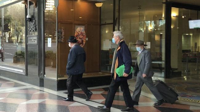 Caruana (right) leaves the court with his lawyer and a supporter on Tuesday.