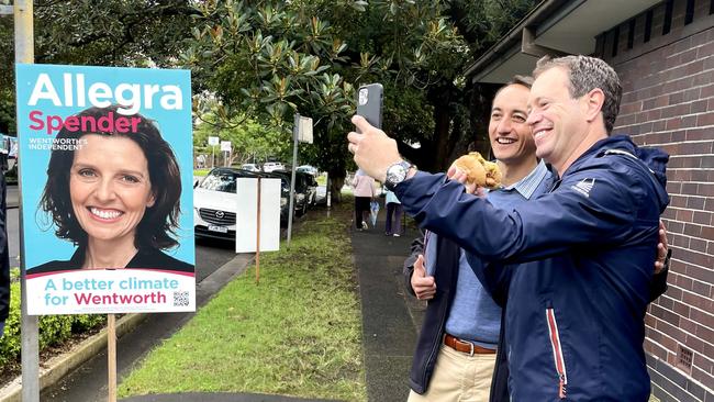 Dave Sharma (back) poses with supporter in front of a poster of his challenger, Allegra Spender. Photo: Clare Sibthorpe