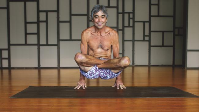 Surf legend, shaper, yogi, and snowboarder Gerry Lopez practicing yoga at Groove Yoga studio in Bend, Oregon.