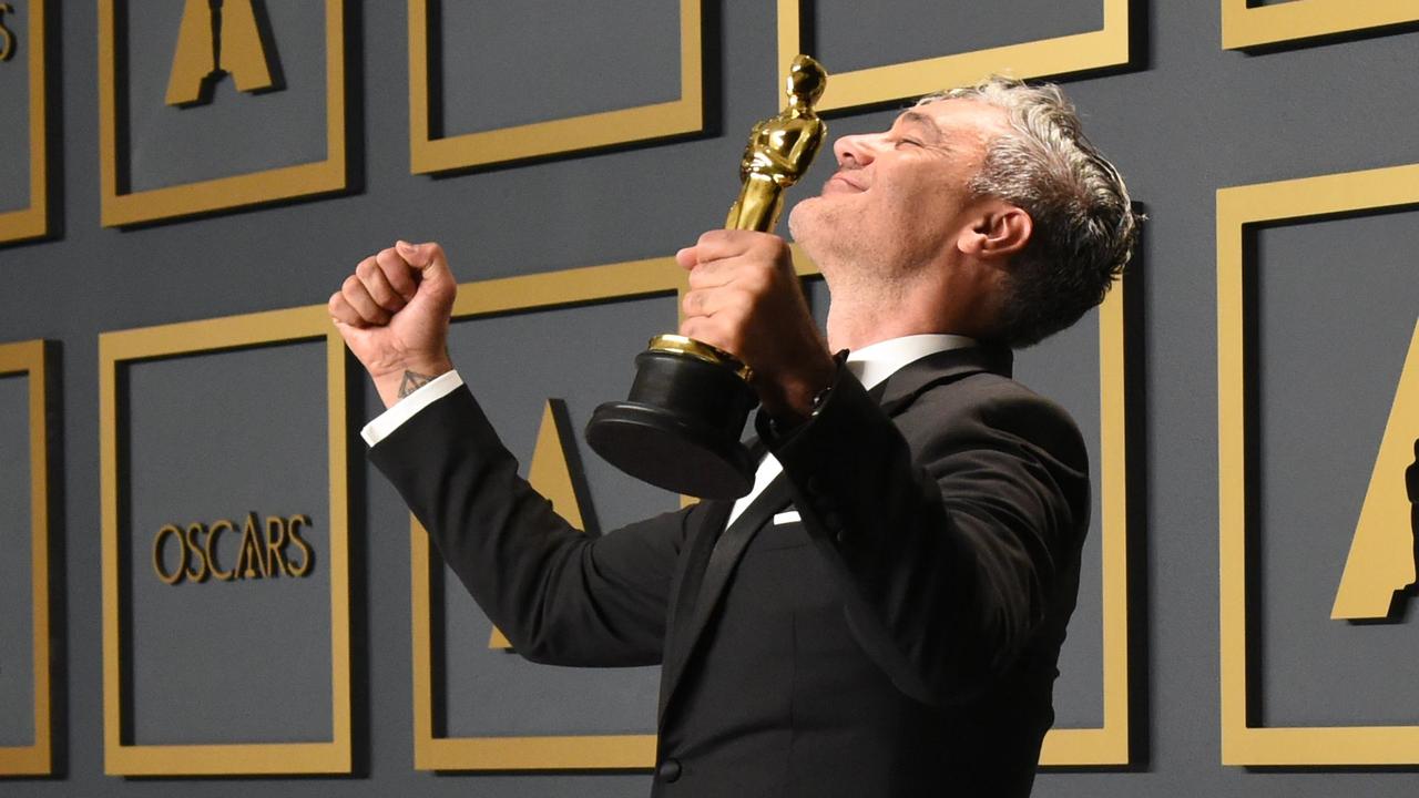 Best Adapted Screenplay: <i>Jojo Rabbit. </i>New Zealand born Taika Waititi, centre, poses with his award. Picture: AFP