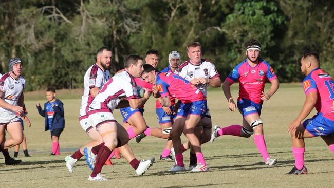 GCDRU (Gold Coast Rugby) first grade clash between Helensvale Hogs (pink) and Nerang Bulls. (white). Scott Sutherland runs. Pic Mike Batterham