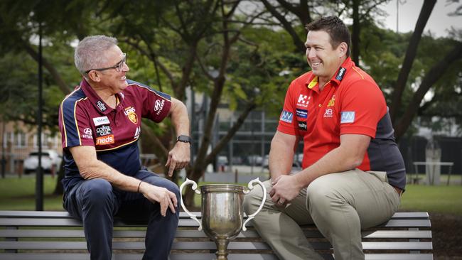 Chris Fagan and Stuart Dew share a laugh with the QClash trophy. Picture: AAP