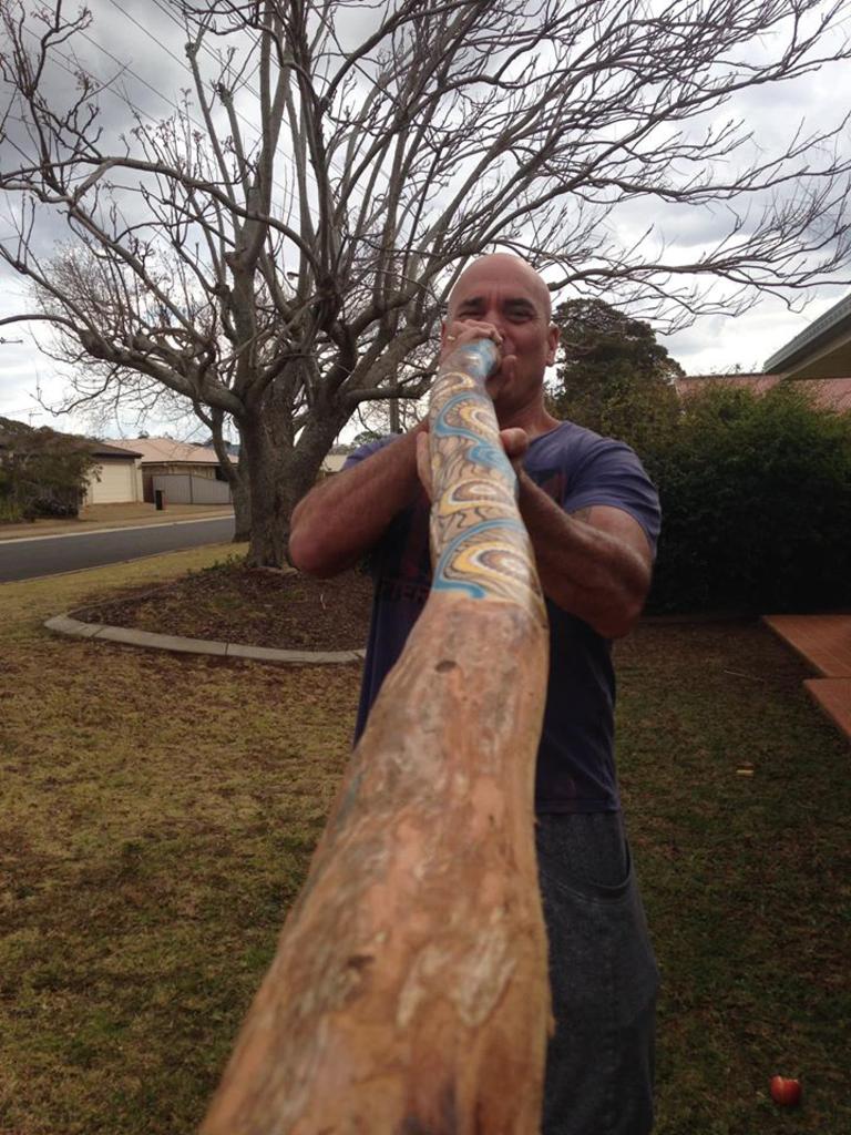 Shearer working on his didgeridoo sills.