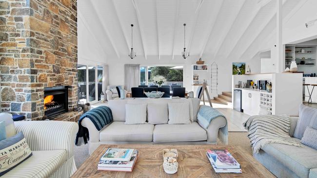 The high ceilings and open fireplace in the open-plan living room.