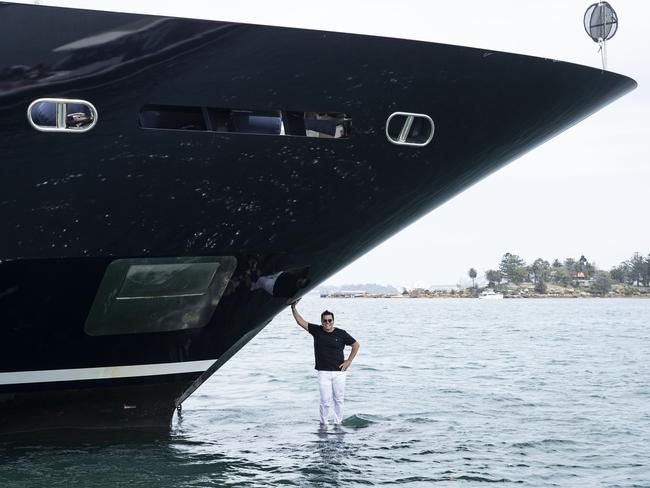 25/11/19: Ian Malouf stands on the bulbous bow of his 62m luxury superyacht Mischief in Sydney having just arrived from from Europe. It will stay here now and be rented out for tens of thousands of dollars an hour. it is the largest of its type in Australia now. John Feder/The Australian.