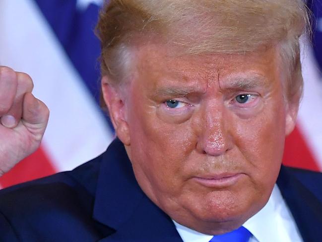 (FILES) In this file photo US President Donald Trump pumps his fist after speaking during election night in the East Room of the White House in Washington, DC, early on November 4, 2020. - The US election was plunged into chaos early November 4, 2020 as President Donald Trump prematurely declared victory and sought Supreme Court intervention to stop vote-counting -- even as his Democratic rival Joe Biden voiced confidence in his own chances. In a divisive election cast under the shadow of the coronavirus pandemic that has claimed more than 230,000 lives in the United States, Trump appeared to have avoided a Democratic wave predicted by some polls but he still needs key states to secure another four-year term. (Photo by MANDEL NGAN / AFP)