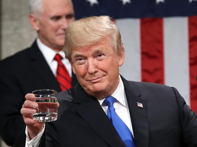 WASHINGTON, DC - JANUARY 30: U.S. President Donald J. Trump holds a glass of water before he delivers the State of the Union address as U.S. Vice President Mike Pence (L) and Speaker of the House U.S. Rep. Paul Ryan (R-WI) (R) look on in the chamber of the U.S. House of Representatives January 30, 2018 in Washington, DC. This is the first State of the Union address given by U.S. President Donald Trump and his second joint-session address to Congress.   Win McNamee/Getty Images/AFP == FOR NEWSPAPERS, INTERNET, TELCOS & TELEVISION USE ONLY ==