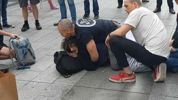 Barry Siecker is pinned down in Rundle Mall after a busker was attacked. Picture: Shaun Hollis