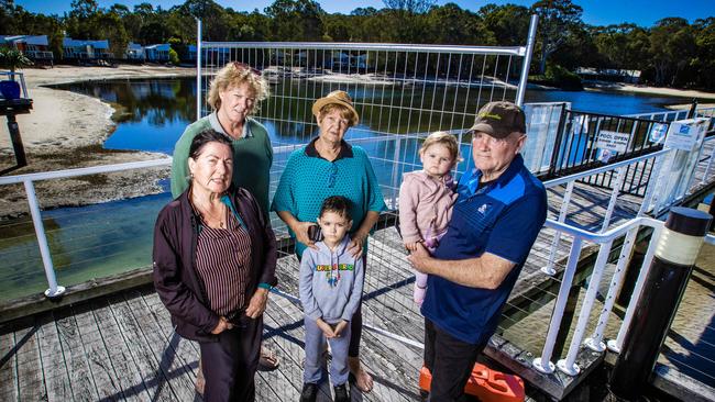 Couran Cove residents Jana Ruzicka, Rhonda Dalgleish, Doreen Grech, Atreyu and James Laverty, holding baby Verona. Picture: Nigel Hallett