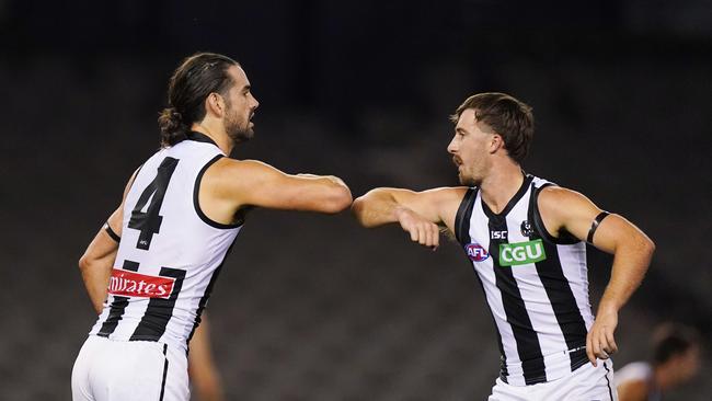 Brodie Grundy and Tom Phillips bump elbows on opening round. Picture: AAP