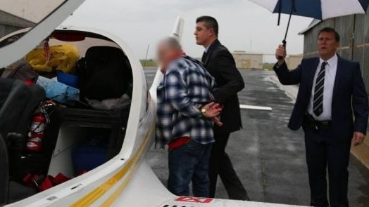 Flying high ... then grounded. John Charles White is arrested on drug trafficking charges at Deniliquin airfield in NSW. Picture supplied by NSW Police.