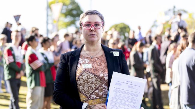 Cori Sandy-Brooke holding an open letter to the Anglican Schools Commission.