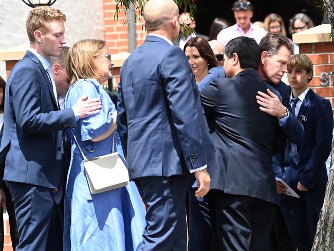 SYDNEY, AUSTRALIA -November 17, 2023.Mother (blue dress) and brother and father ( Right)  of Lilie James who was murdered recently leave the funeral service at Danebank College . Picture: Jeremy Piper