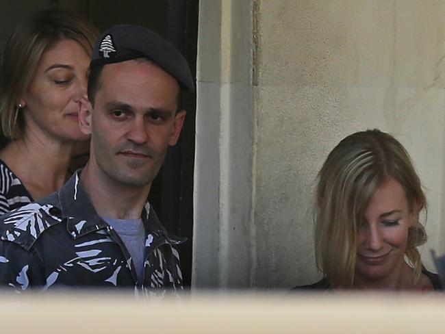 Sally Faulkner, right, and Tara Brown, left, escorted by a Lebanese policeman, centre, leave the women’s prison. Picture: AP.