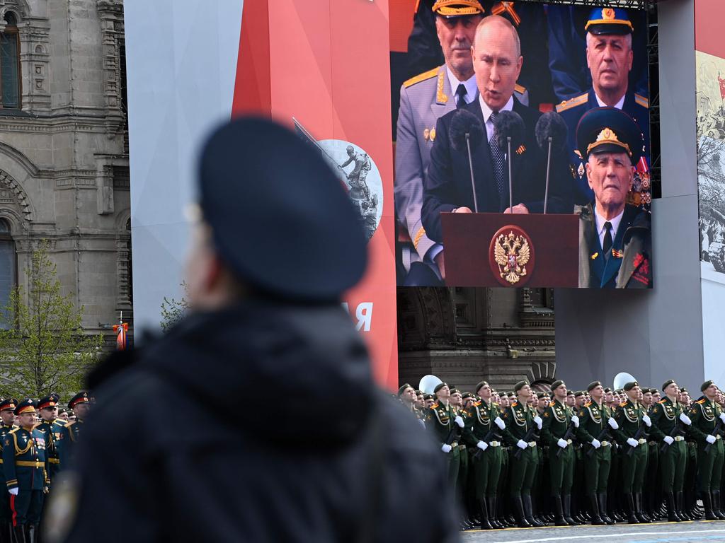 A screen shows Russian President Vladimir Putin giving a speech as servicemen line up on Red Square during the Victory Day military parade. Picture: Kirill Kudryavtsev / AFP