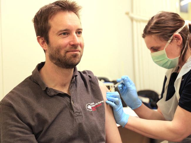 Rothera Station Leader Matthew Phillips (L) receives a dose of the Oxford/AstraZeneca Covid-19 vaccine in Antarctica. Picture: AFP