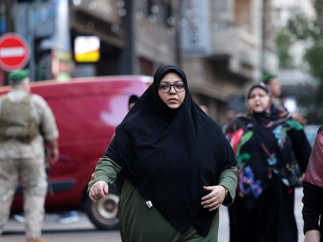 Friends and relatives walk towards a hospital in Beirut where wounded people were transported. Picture: AFP