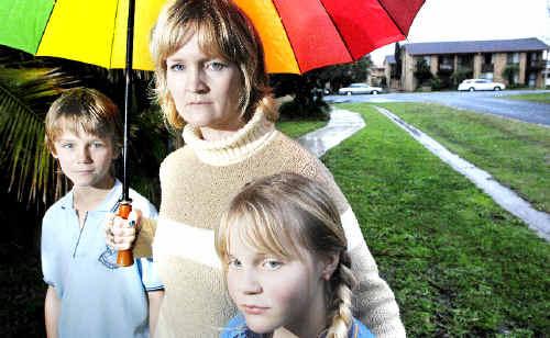 Anthony Buckingham, 11, and Tamsin Buckingham, 10, with mum Richelle Buckingham of Ballina, who has been taken to court and fined by the Ballina Shire Council for having a trampoline set up on the footpath. . Picture: Jay Cronan