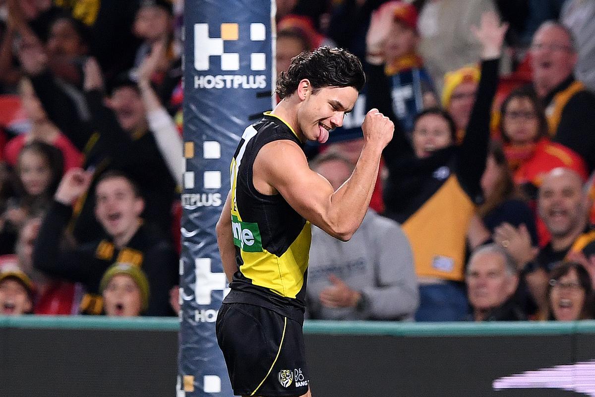 Tigers player Daniel Rioli reacts after kicking a goal during round 19