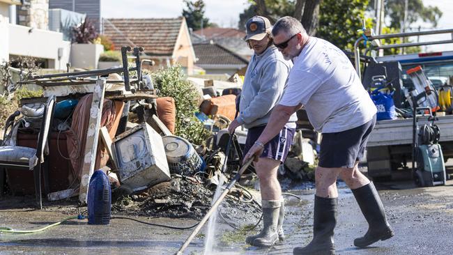 Residents in Maribyrnong begin the clean-up after recent flooding. Picture: NCA NewsWire / Aaron Francis