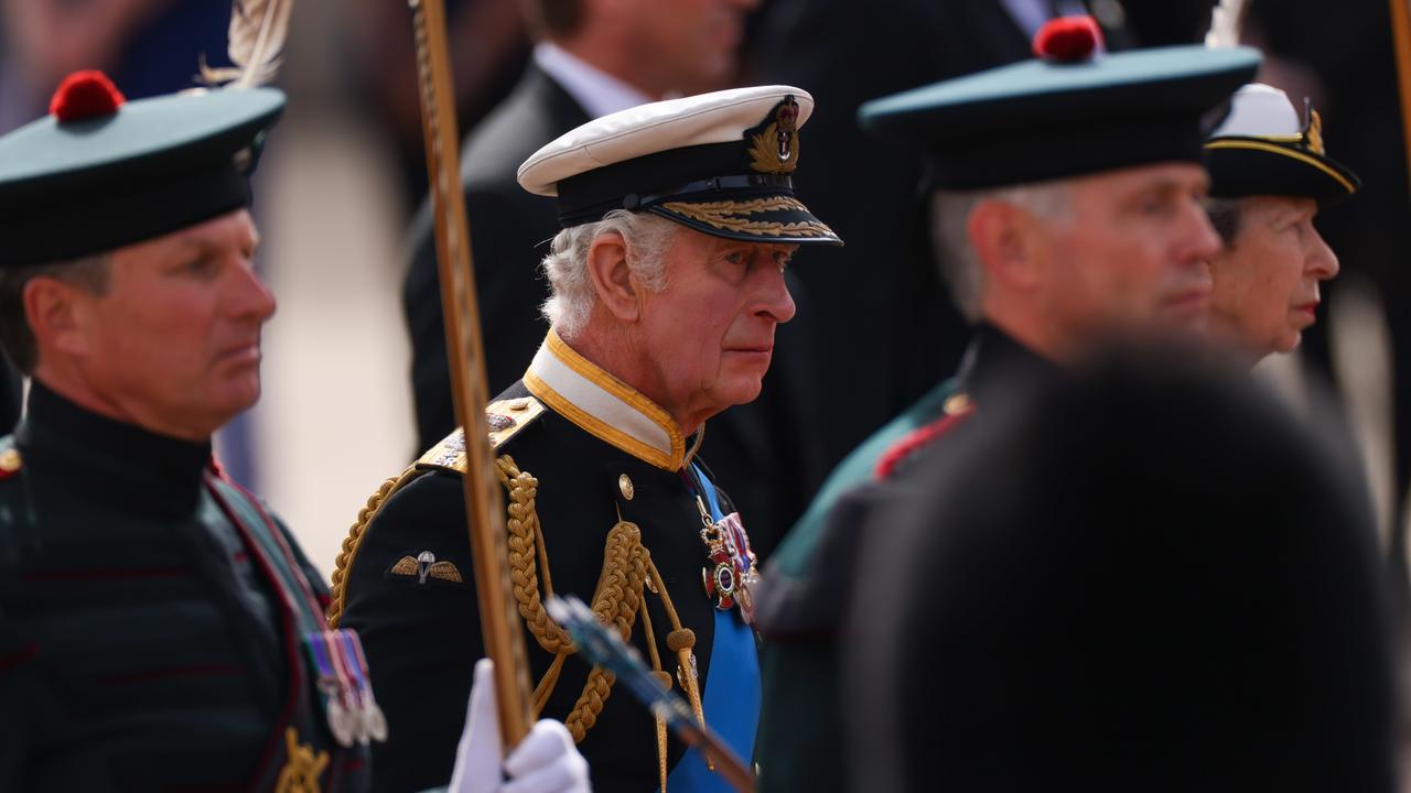 Teary King Charles III passes Buckingham Palace as he marches in the procession during the state funeral of Queen Elizabeth II.