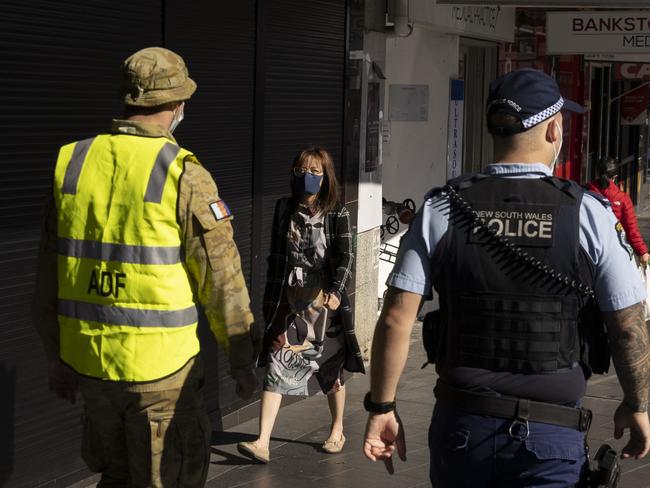 Australian Defence Force soldiers and NSW Police patrol the Bankstown CBD on August 7. Picture: Getty