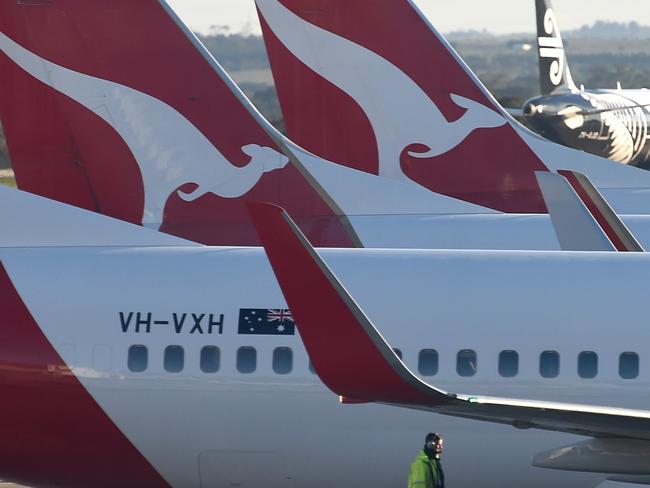 A worker checks the wings for ice. Qantas planes, Melbourne airport. Melbourne has shivered through a cold Winter's morning. Picture: Nicole Garmston