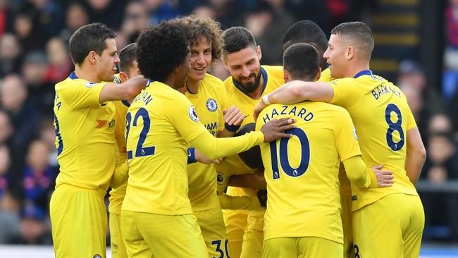 Kante is mobbed by his Blues teammates.