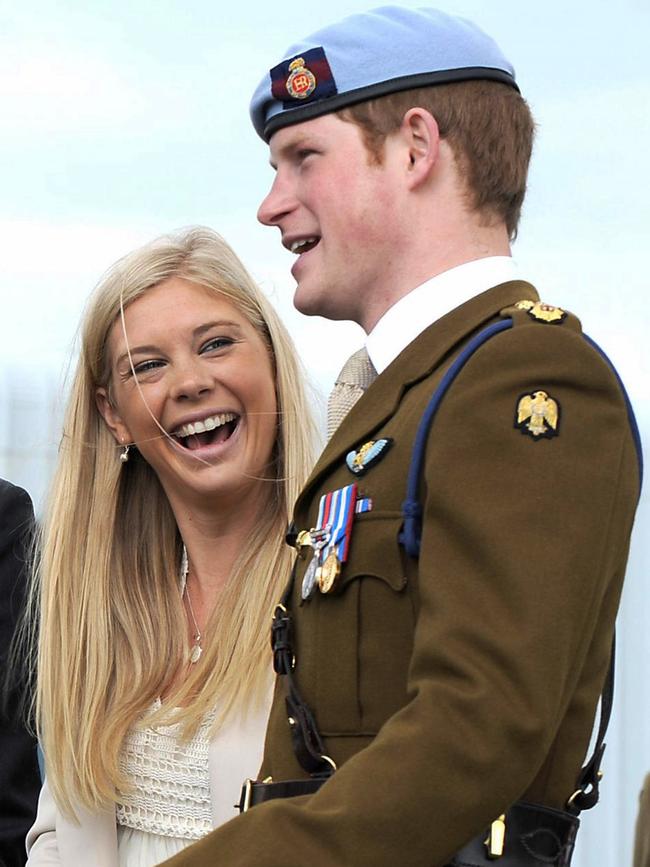 Prince Harry talks with his girlfriend Chelsy Davy after receiving his Helicopter Pilot's wings from his father, Prince Charles, in a graduation ceremony in 2010. (AP Photo/Richard Dawson)