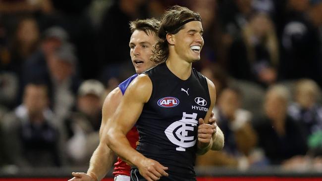 Liam Stocker shares a laugh with Lincoln McCarthy after kicking a goal at the wrong end. Picture: Michael Willson/AFL Photos/Getty Images