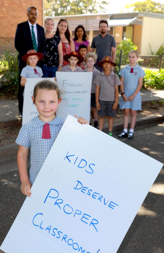 Kendall Mathews, 6, and fellow students and parents protest over the increasing number of demountables popping up at their school at Epping West.