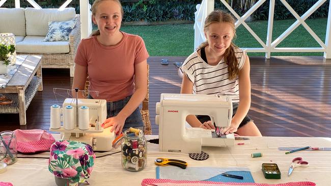 Imogen and Lottie Burns have spent their school holidays sewing scrub caps.