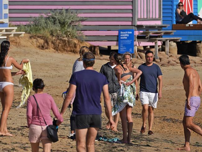 People walk along Brighton beach in Melbourne on Monday. Picture: AAP.