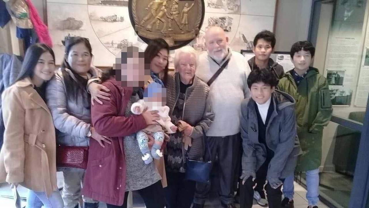 From left: Flordeliza Dolar, 19, Divine Dolar, 56, name withheld, Mika Clariman (baby), Diseree Brown, Paul Brown's mum, Paul Brown, Mark Lagud (front, blue jacket), Pedro Clariman (back), Luie Lagud (right, green jacket).