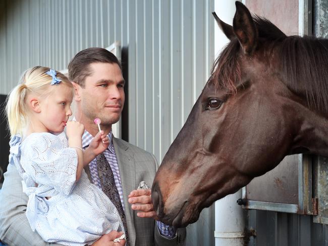 Tom with daughter Primrose at trainer Danny O'Brien's stables. Picture Rebecca Michael.