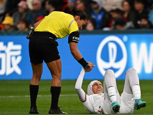 Brazilian referee Edina Alves (L) helps Nouhaila Benzina to her feet after a challenge. Picture: Brenton Edwards/AFP