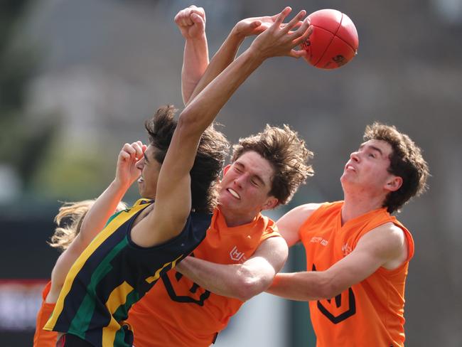 Ashwin Currie of St Kevin's College attempts to mark the ball during the Herald Sun Shield Inter Boys Div 1 Grand Final.