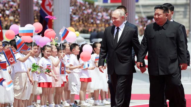 Children bearing colourful balloons were there to greet Vladimir Putin during a welcoming ceremony. Picture: AFP