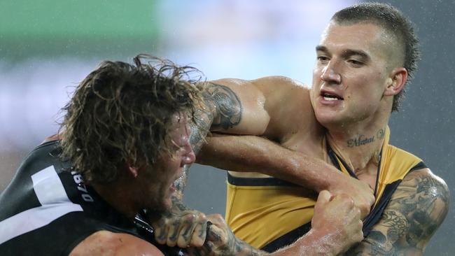 Dustin Martin throws his weight around against Brad Ebert. Picture: Calum Robertson