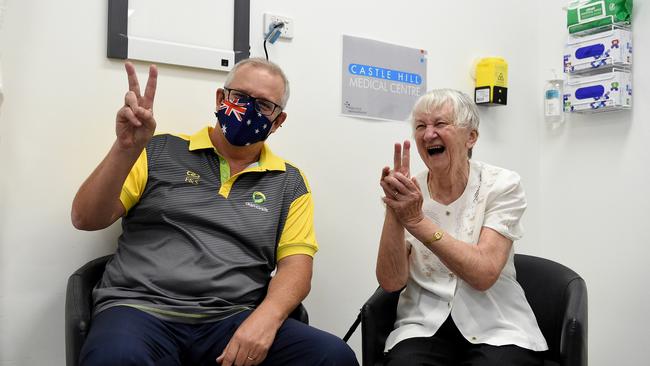 Prime Minster Scott Morrison and aged care resident Jane Malysiak gesture after receiving their second and final COVID-19 vaccination shot. Picture: Bianca De Marchi