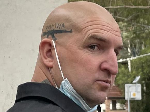 An alleged neo-Nazi extremist has admitted to intimidating and assaulting a Black Lives Matter activist in his Arncliffe home. Desmond Liddington â who has distinctive tattoos on his body and bald head, including an AK-47 gun with the word RAHOWA â appeared in Sutherland Local Court on Tuesday where he pleaded guilty to two charges. Liddington was charged with stalking/intimidation and affray charges after he and two others allegedly went to the home of Black Lives Matter activist Padraic âPaddyâ Gibson on December 4, 2021 in Arncliffe and used unlawful violence towards him. Picture: Ashleigh Tullis