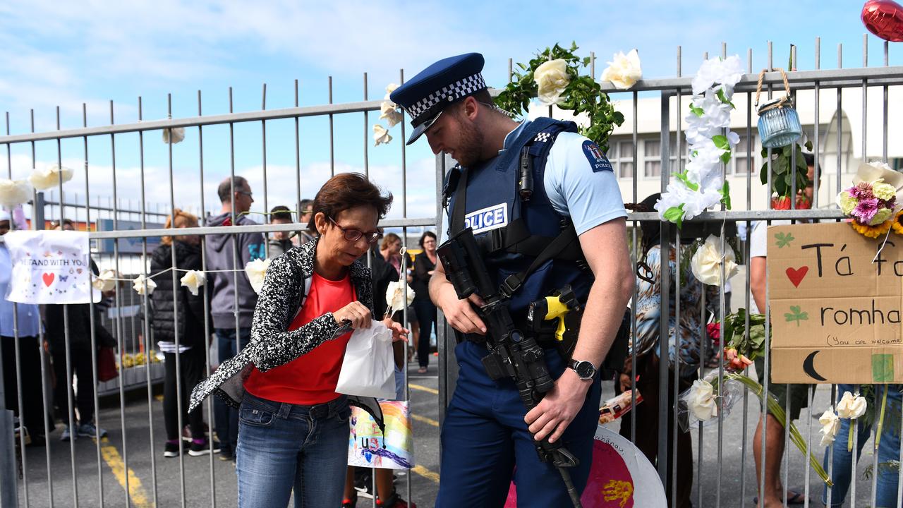  A local offers a police officer a treat from the bakery.