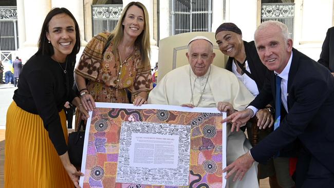 Pope Francis is presented with a copy of the Uluru Statement at the Vatican.