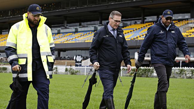 Rosehill track manager Shaun Patterson, chief steward Marc Van Gestel and ATC track manager Nevesh Ramdhani checking the track at Rosehill Racecourse. Picture: Adam Yip