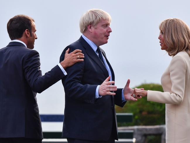 French President Emmanuel Macron looks on as his wife Brigitte welcomes Britain’s Prime Minister Boris Johnson. Picture: AFP