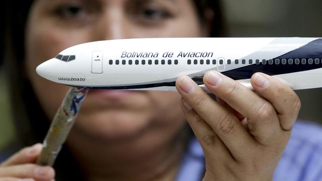 In this Feb. 5, 2015 photo, Diocelina Barajas applies decals to a model plane at Pacific Miniatures in Fullerton, Calif. When airlines open new routes, make deals with other carriers or finance new jets, there is a gifting of high-quality models. They are used to break the ice at difficult meetings, are tremendous marketing tools and a favored way of saying thank you. (AP Photo/Chris Carlson)